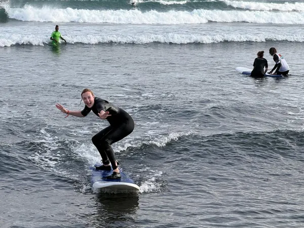Student riding a wave with Kabungo
