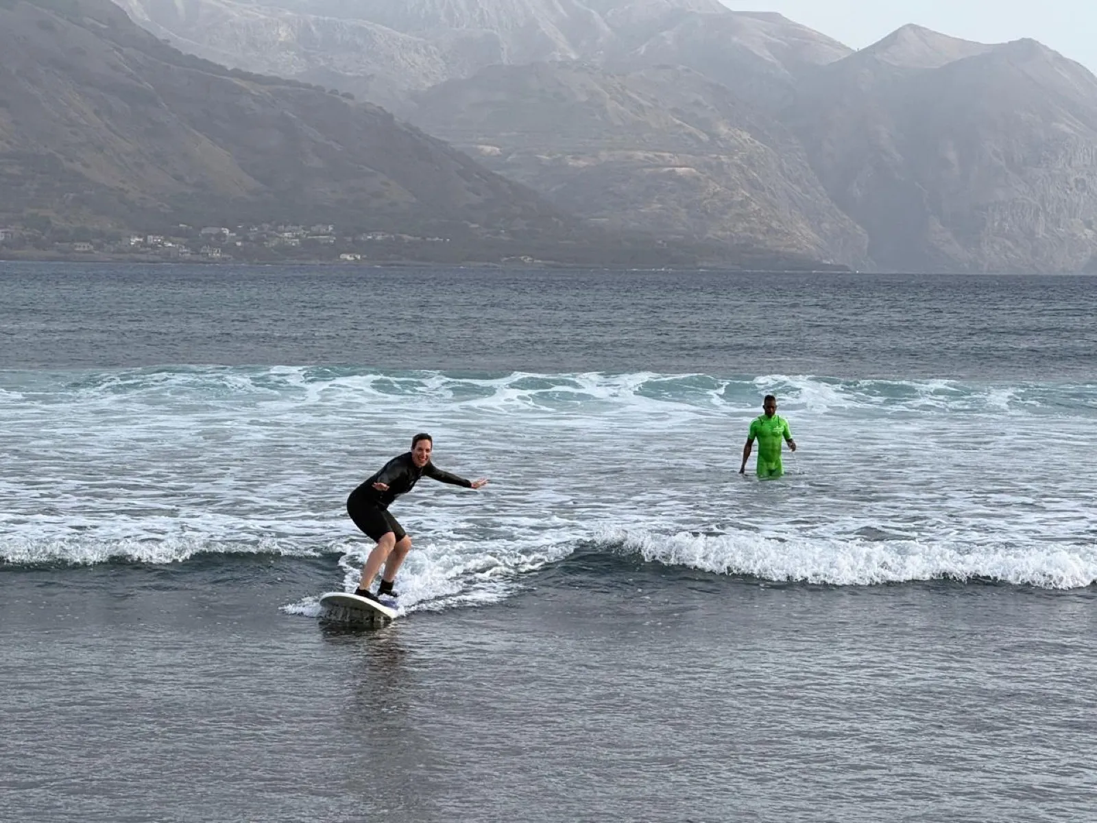 Woman surfing with Kabungo coaching